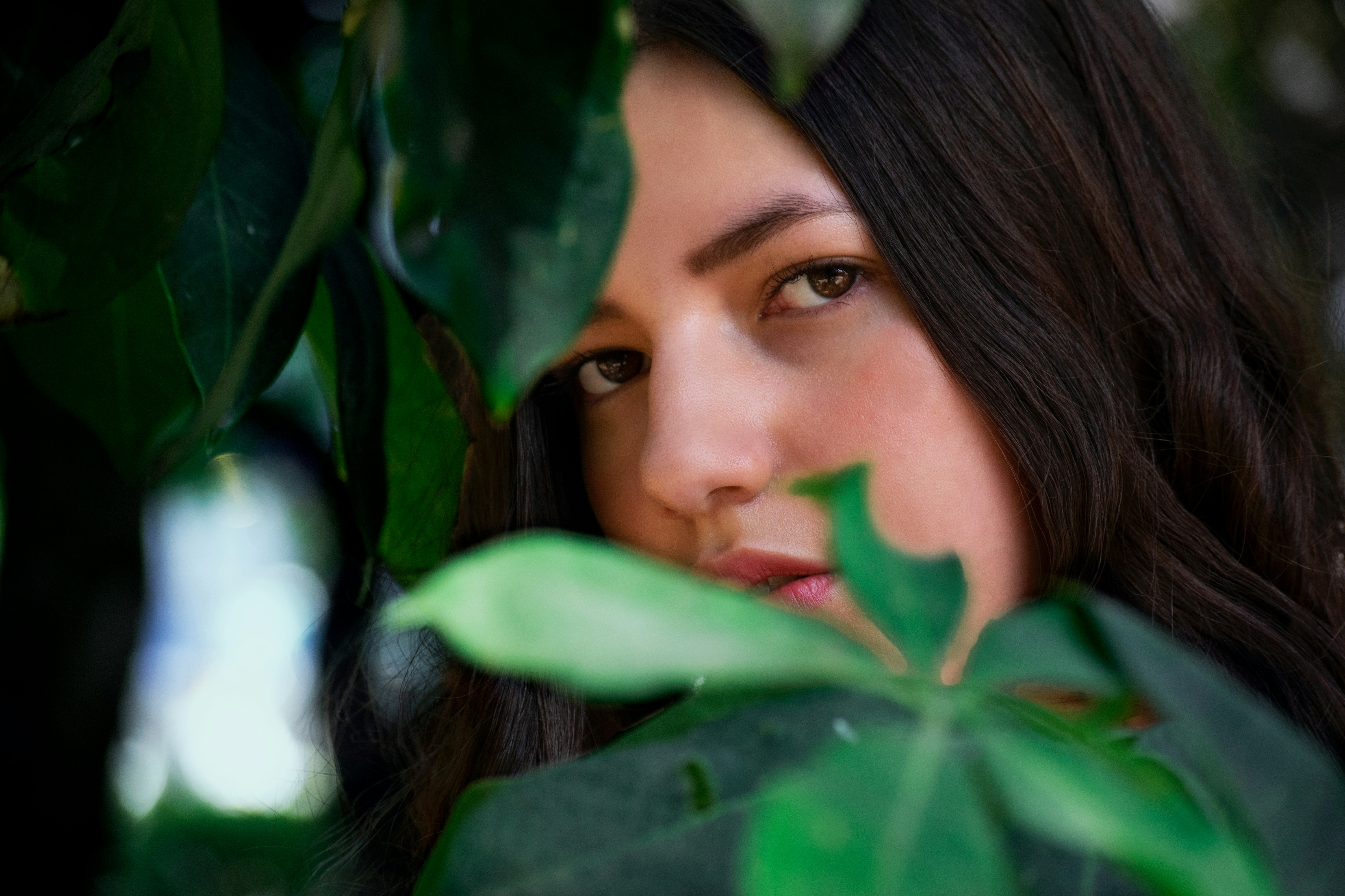 woman behind shade of leaves - Clear Spring Color Analysis