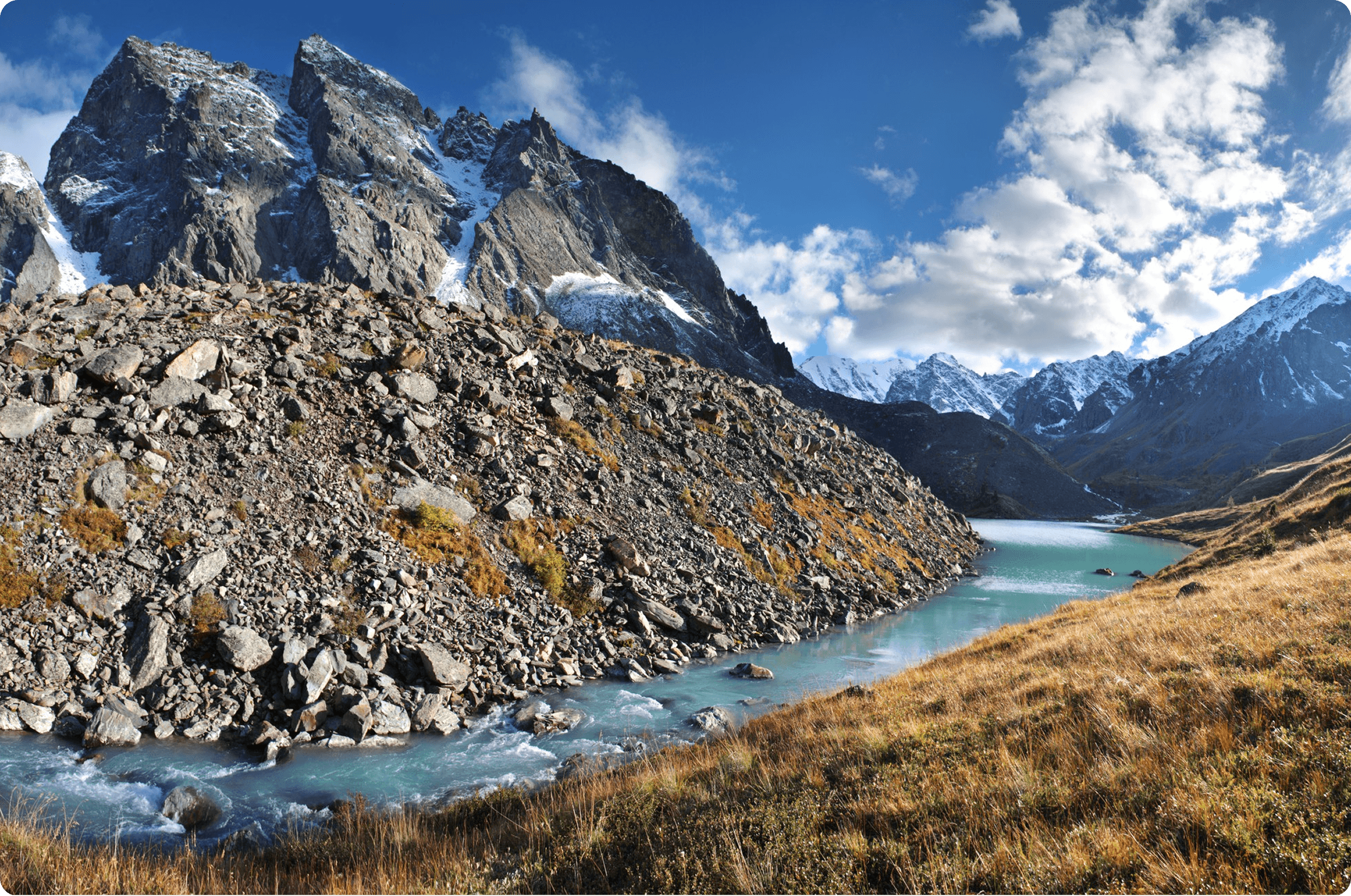 Turquoise river winding through rocky mountains under a blue sky. Like Dislike