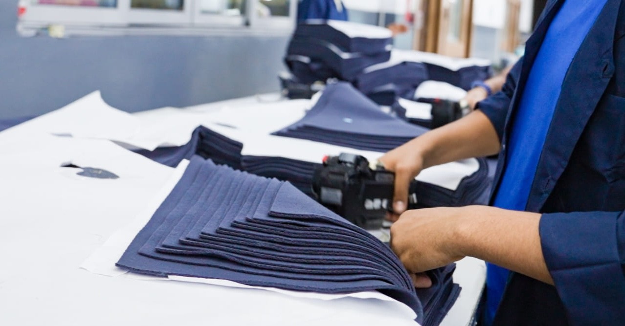 Worker with fabric pieces.