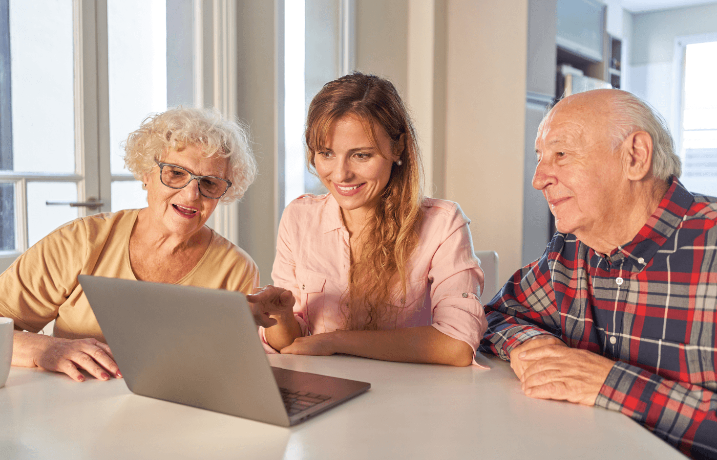 young woman and elderly parents look at computer