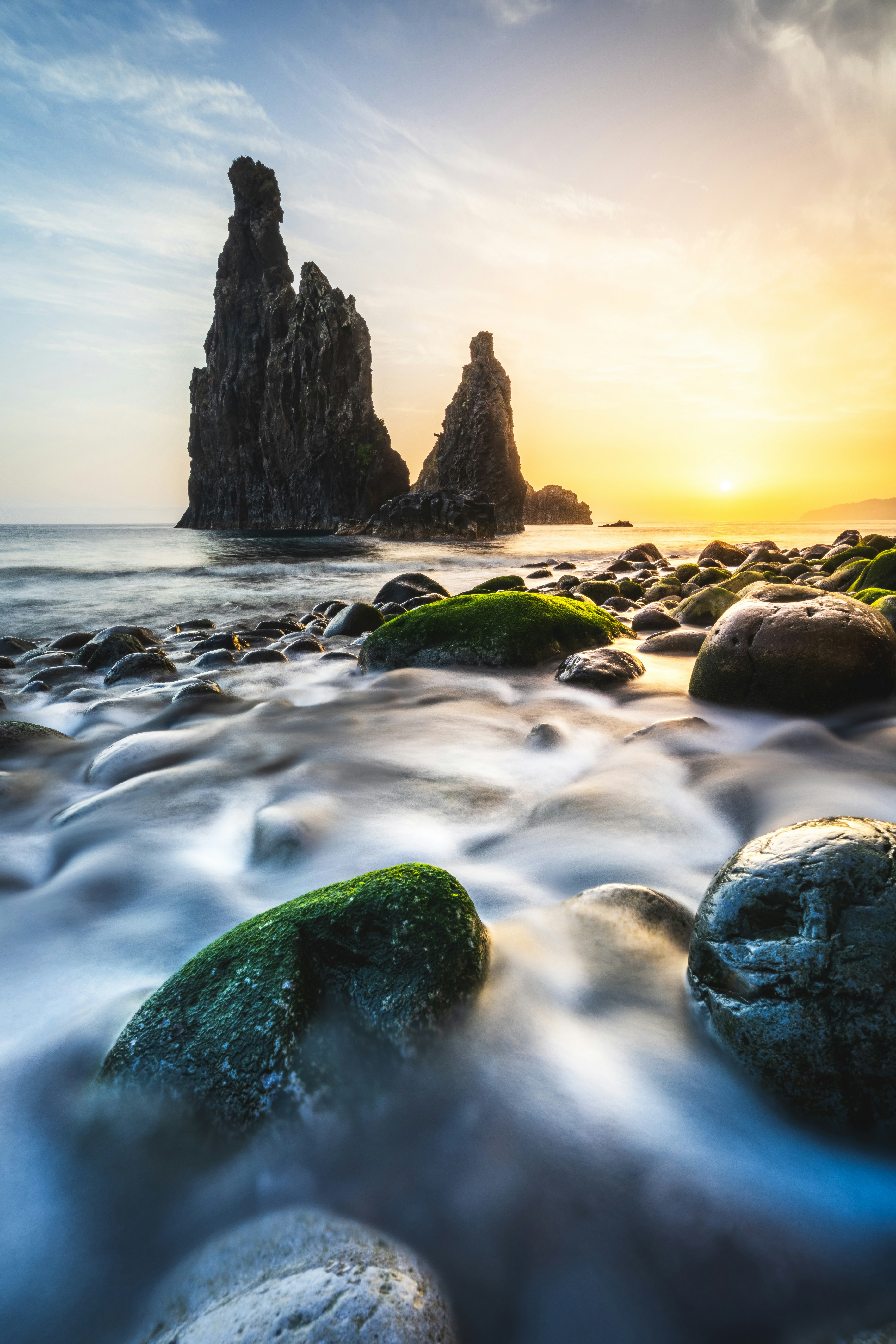 Dramatic rock formations on a rocky beach at sunset
