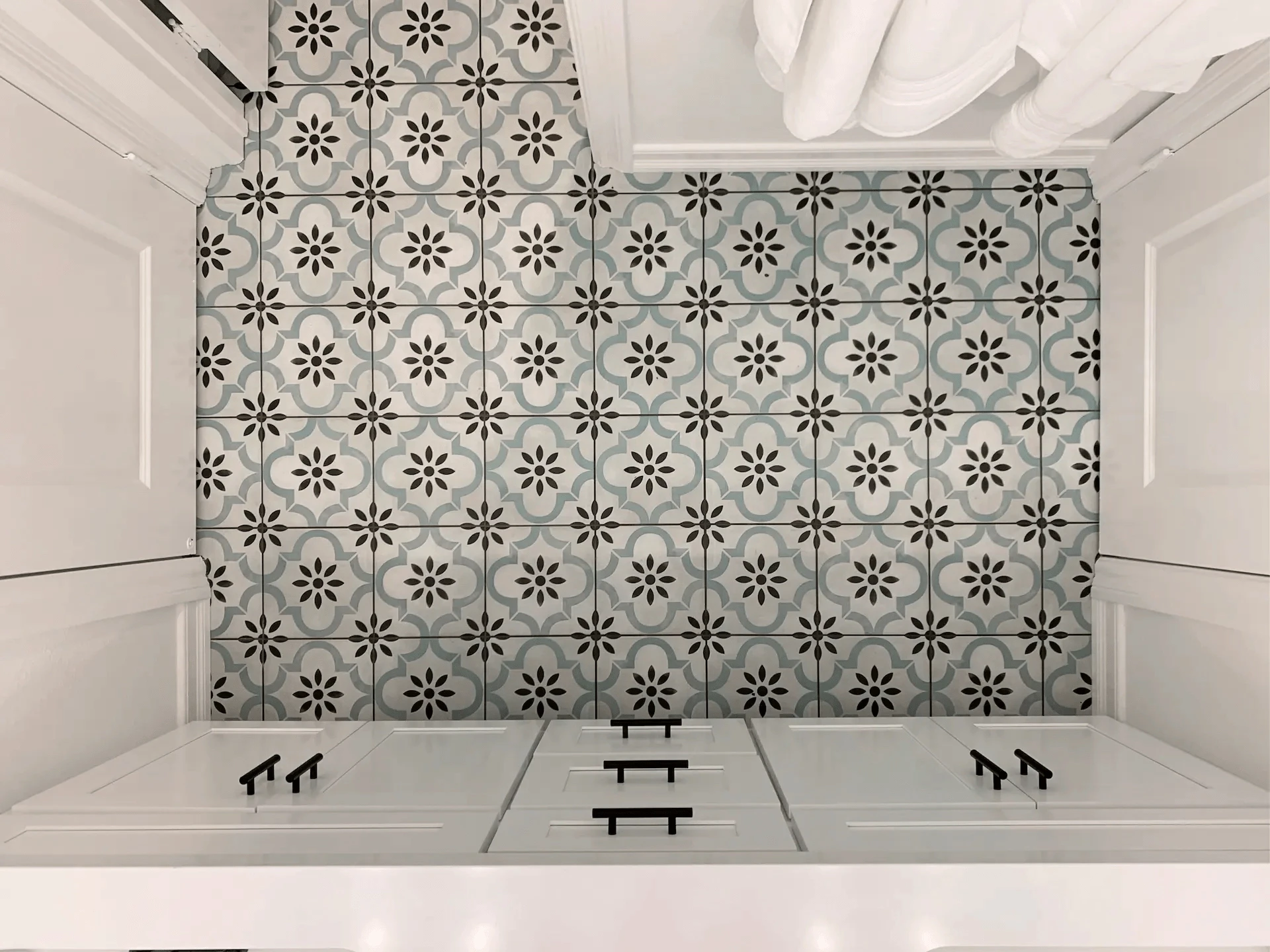 Overhead view of the kids' bathroom floor tile, displaying the painted pattern tiles that add a playful yet sophisticated touch. Photo by Todd Huge.