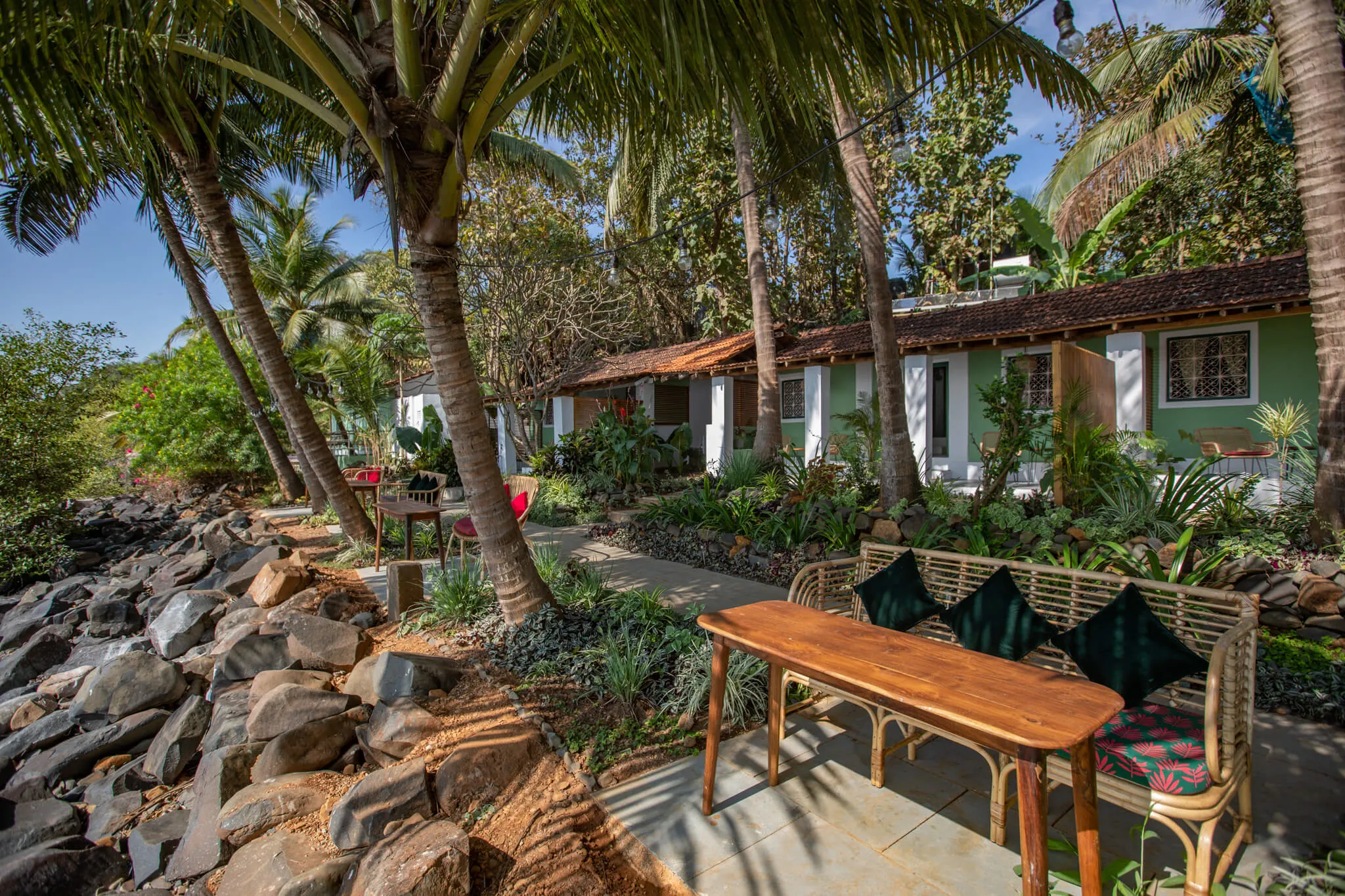 Garden tables on the rocky shore at Casa Jaali