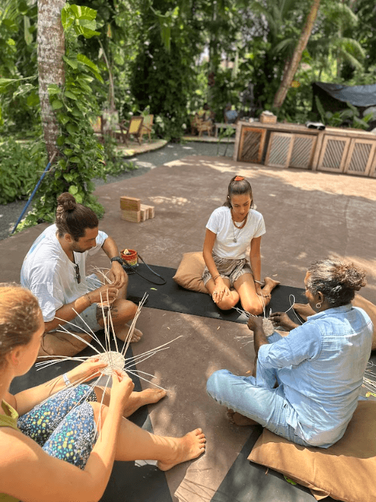 a group of women standing on top of a sandy beach