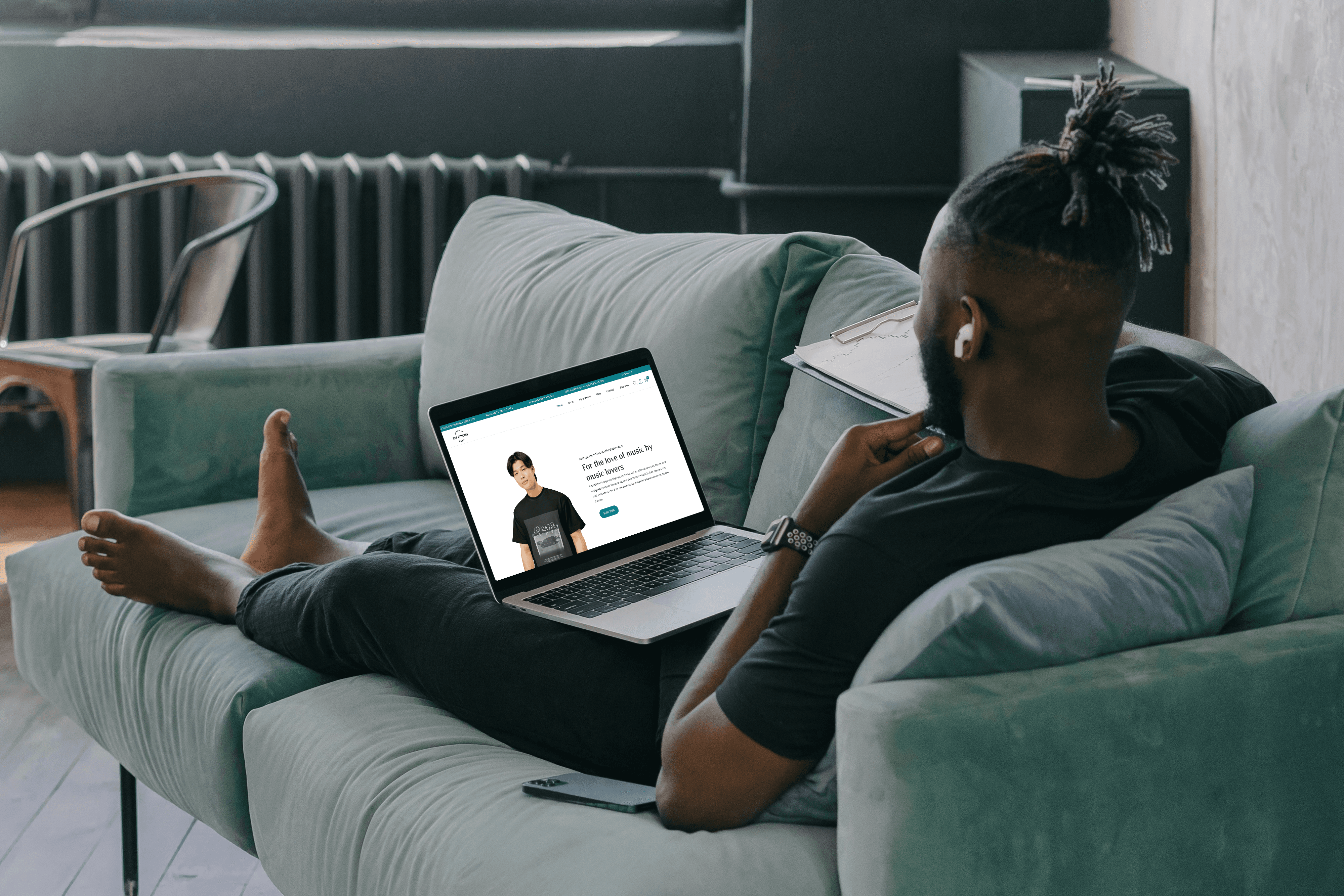person leaning on wall while holding gray hat
