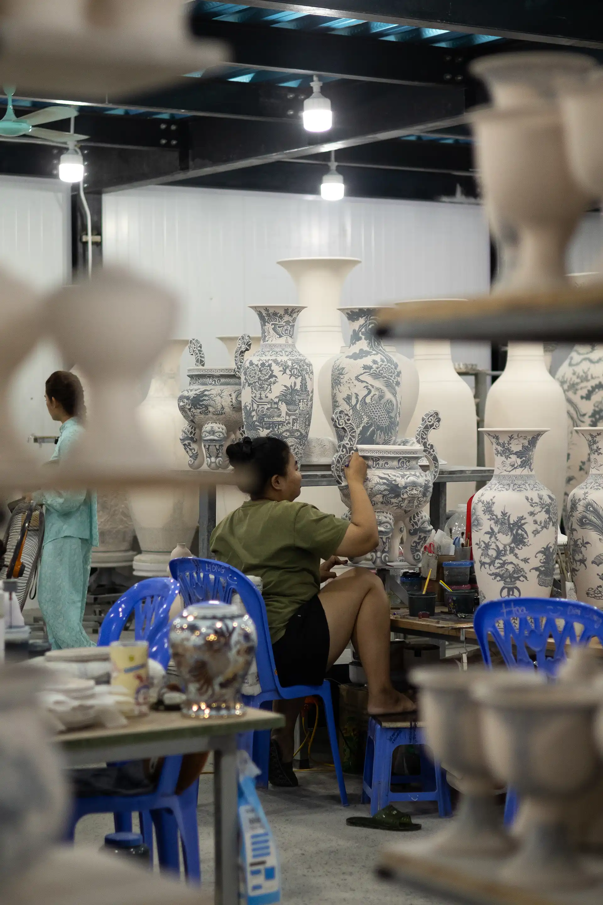 Person painting on a ceramics vase