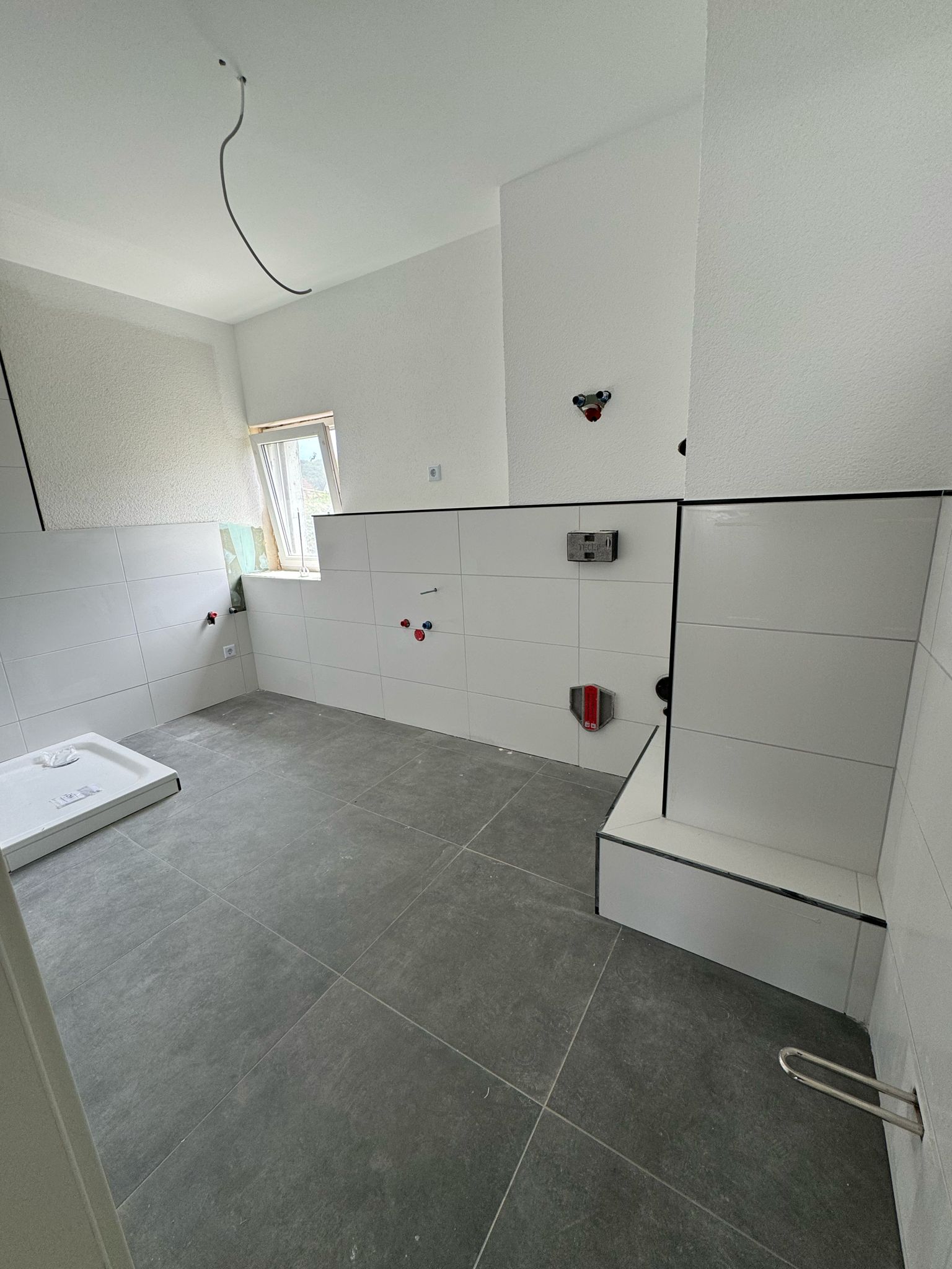 white and brown concrete building near green grass field during daytime