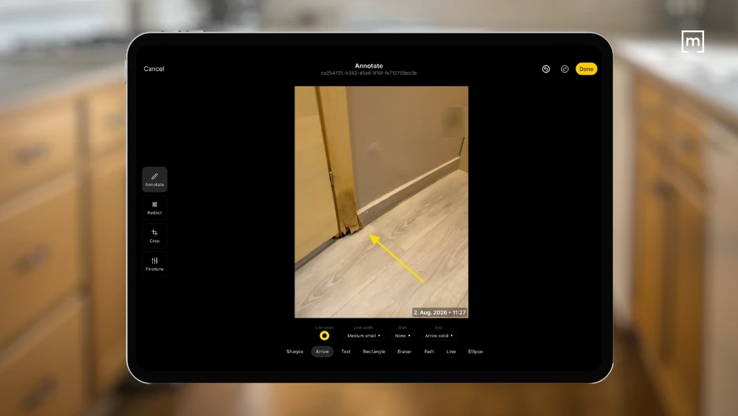 tablet showing an image of a door damaged by water