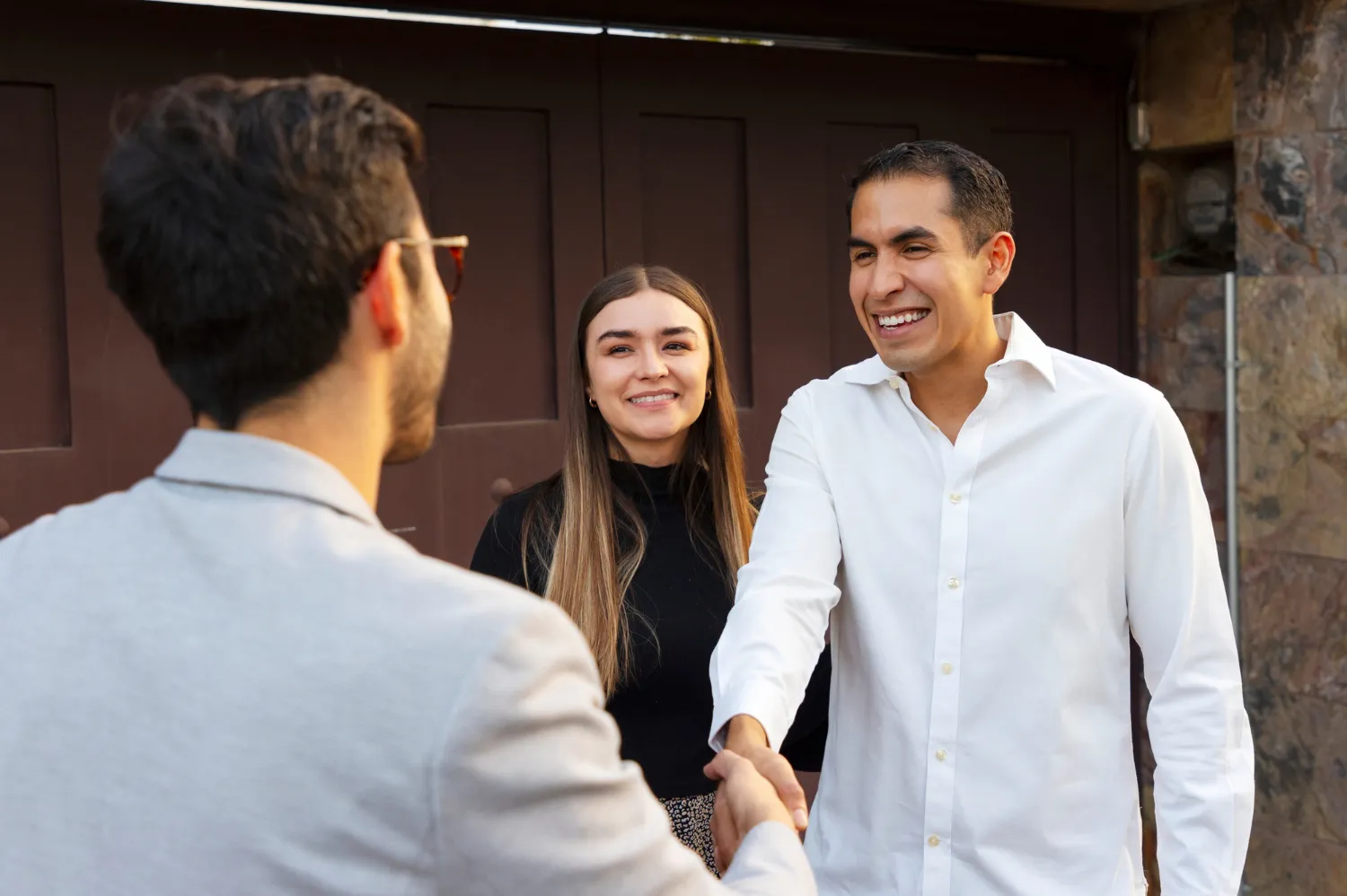 A real estate agent shaking hands with a customer.