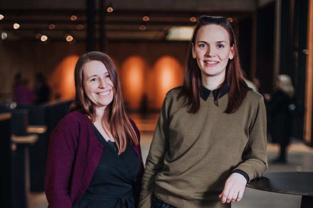 Image of two women standing in an event hall