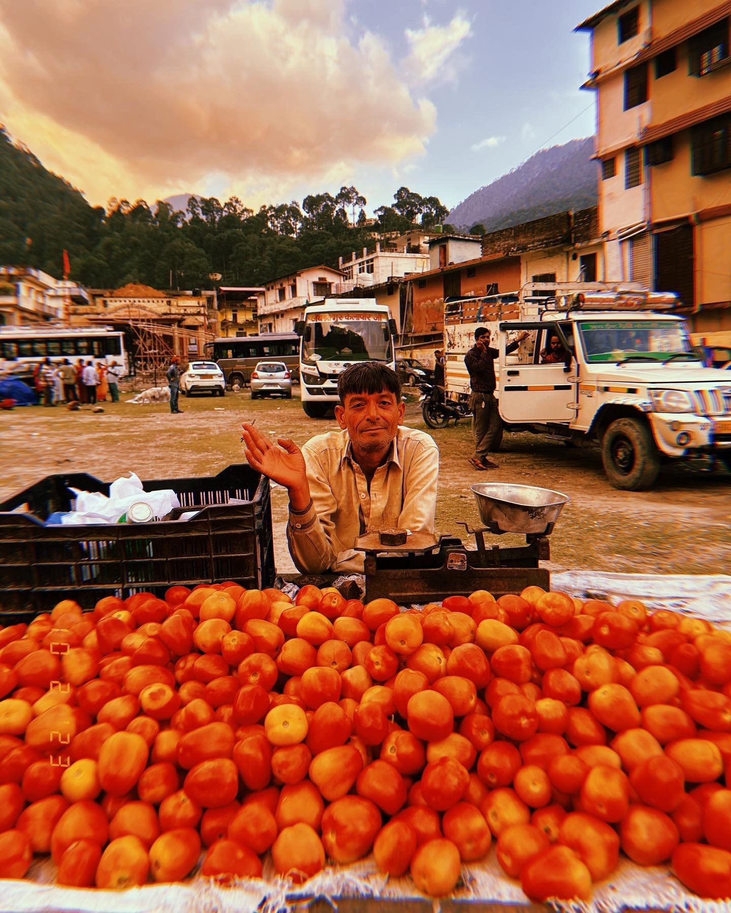 Man behind a tomato stand in a mountain town