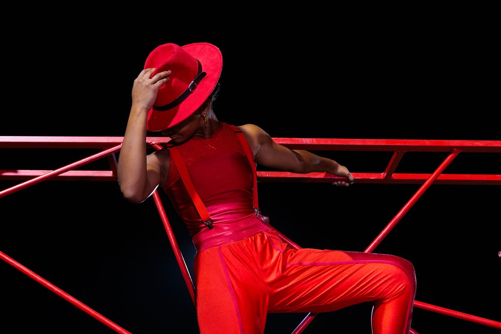 Arianna Ware holding a red fedora