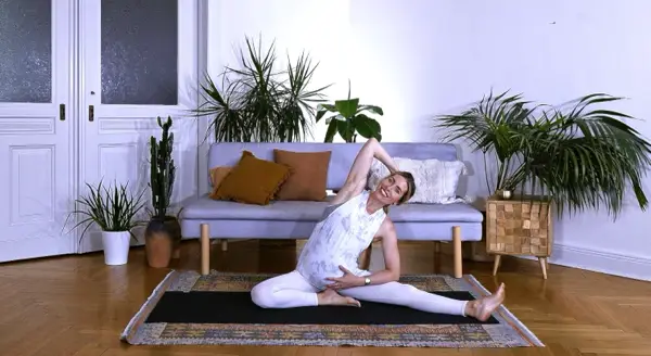 Pregnant woman in a ground-based slow yoga stretch – Day 3 gentle prenatal yoga to protect joints and stretch muscles with careful modifications