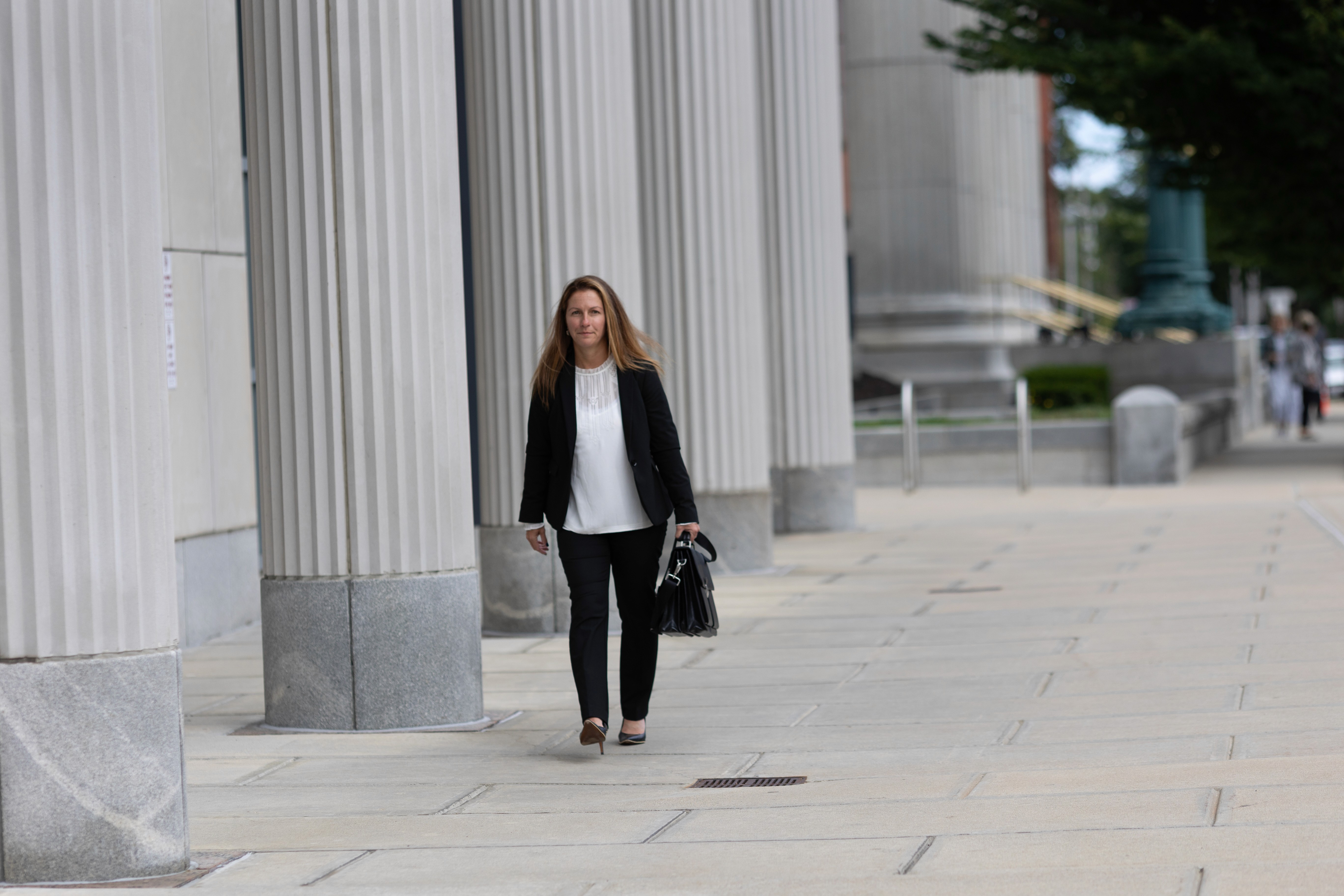 Monique Boucher Lamb, Founding Attorney at Lamb & Lamb, P.C., walking outside the Essex County Probate and Family Court in Salem, MA