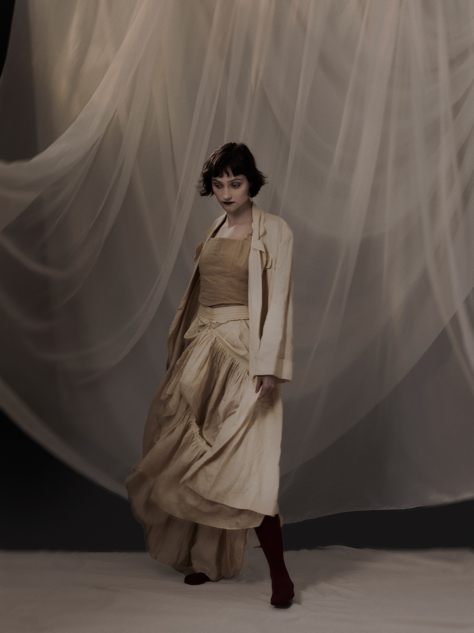 Fashion portrait of a young woman moving in a poetic and expressive way. Shot in the photo studio in New Orleans, by photographer Craig Mulcahy. 