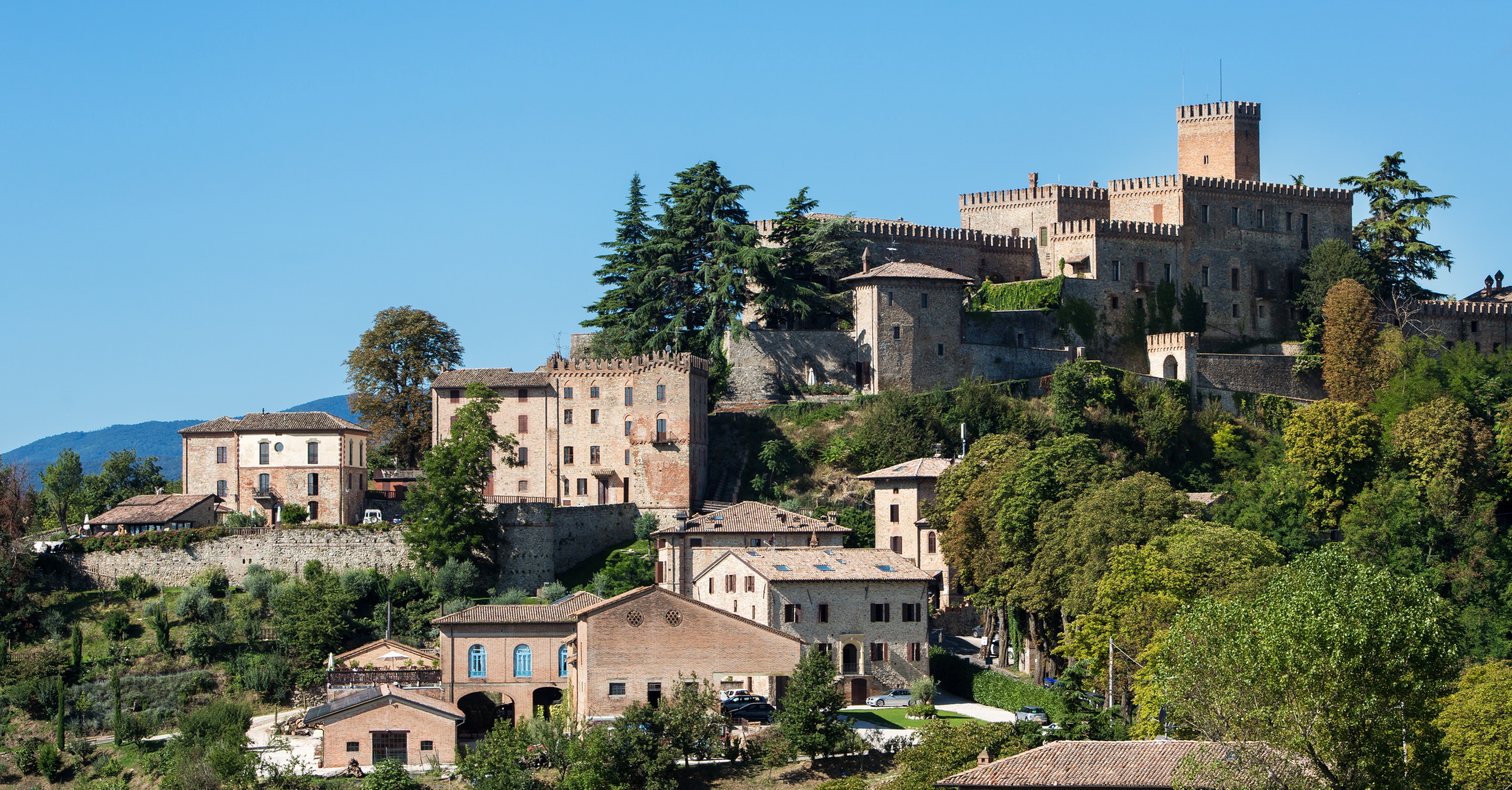 yellow 3-door hatchback parked outside a building