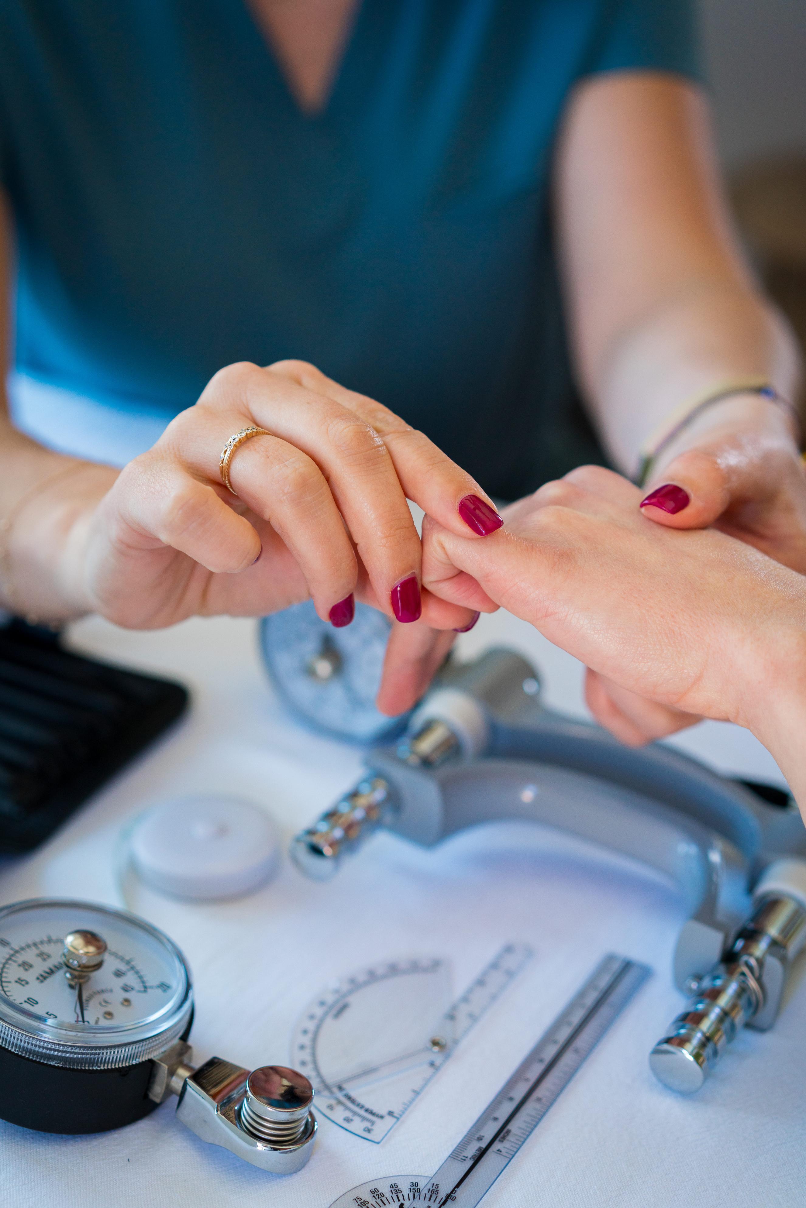 Image of therapist performing passive stretch to a stiff finger