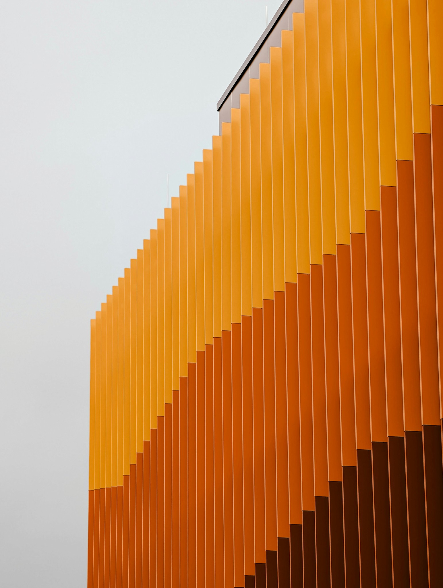 Modern building facade with orange and brown vertical slats