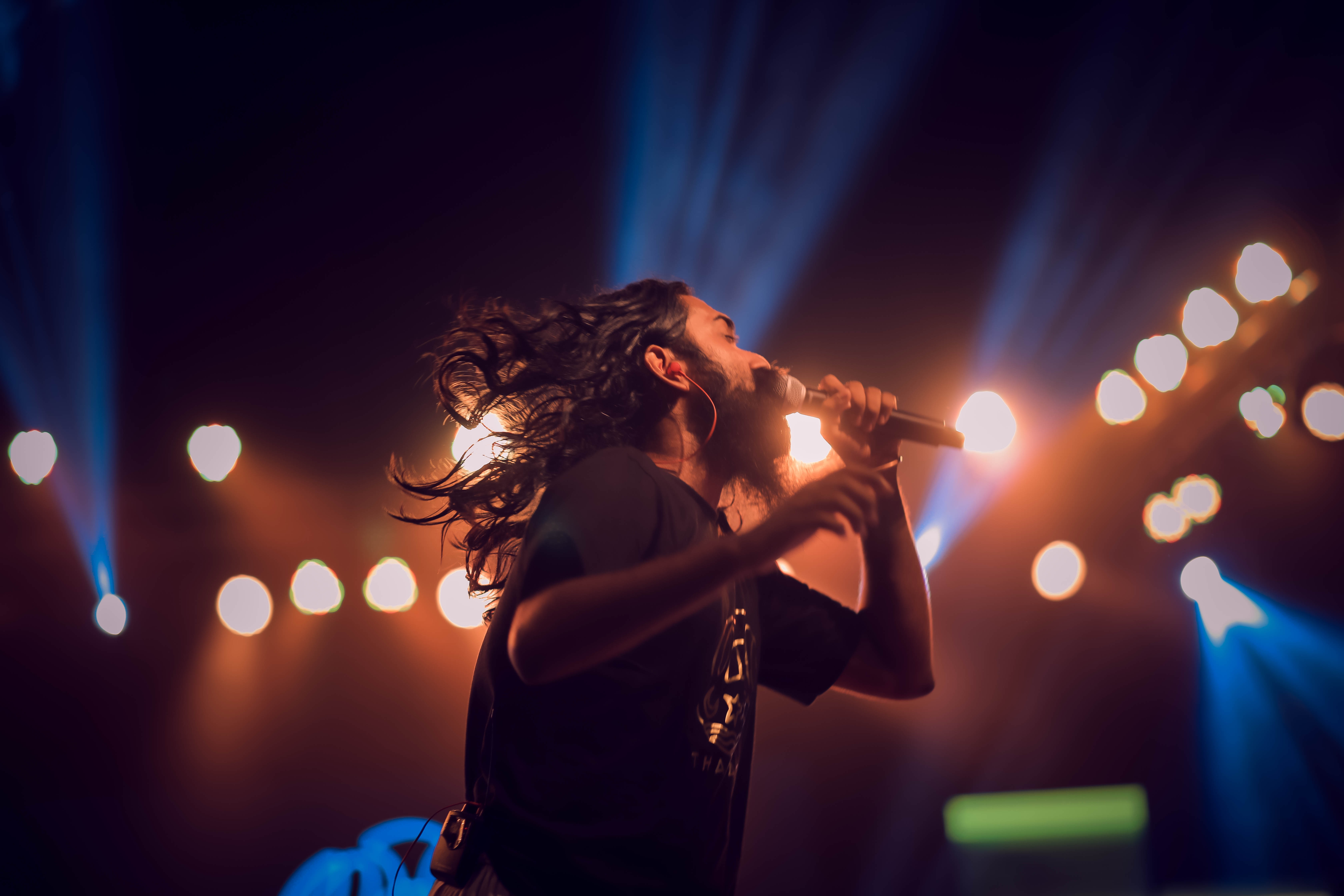 singer with mic on stage - how to write love songs