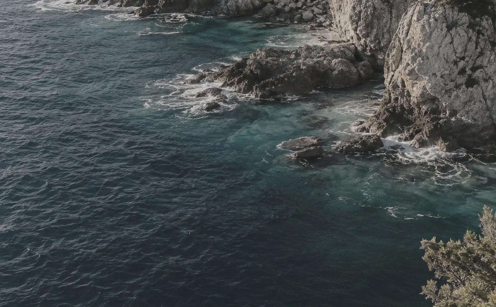 The same coastline, ungraded: flat, grey and cool
