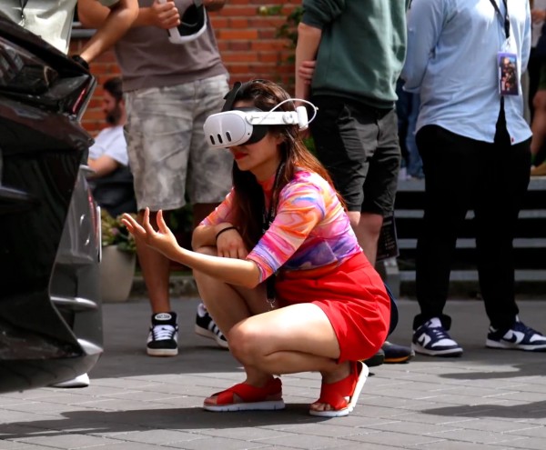 woman using an MR app next to a CUPRA car