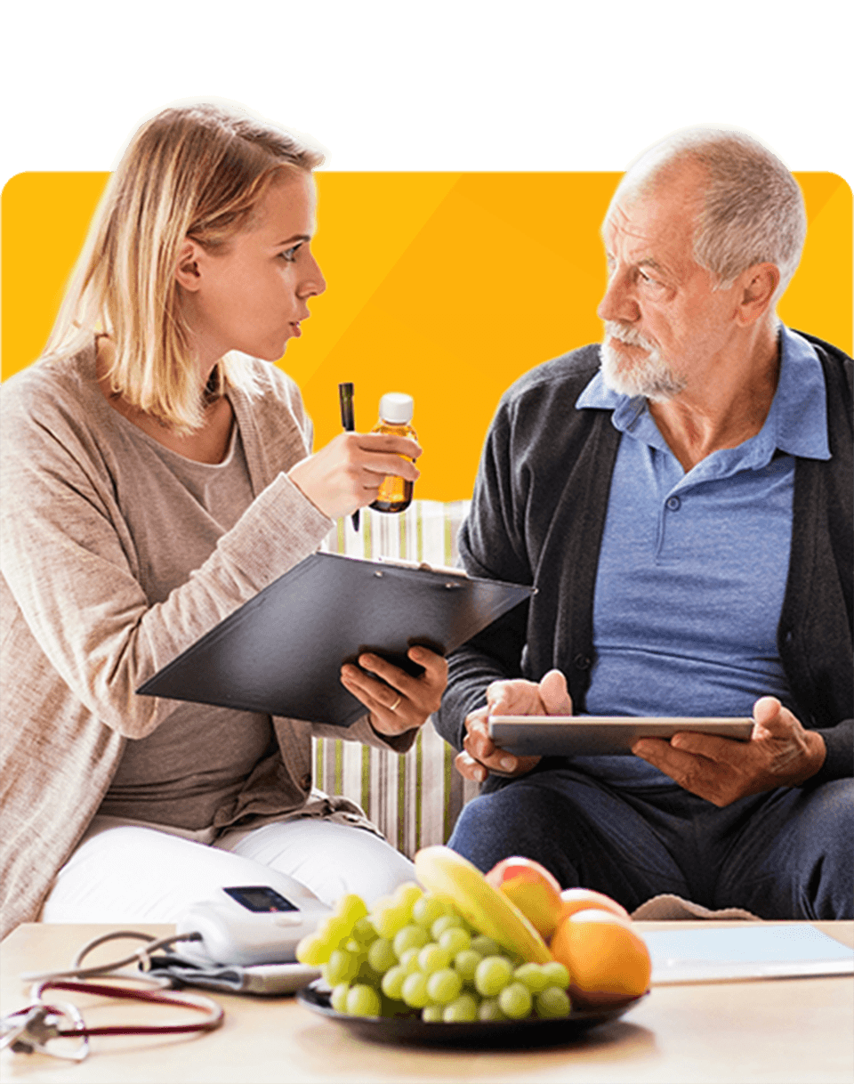 A woman and an older man engage in conversation, surrounded by food on a table. They appear thoughtful.