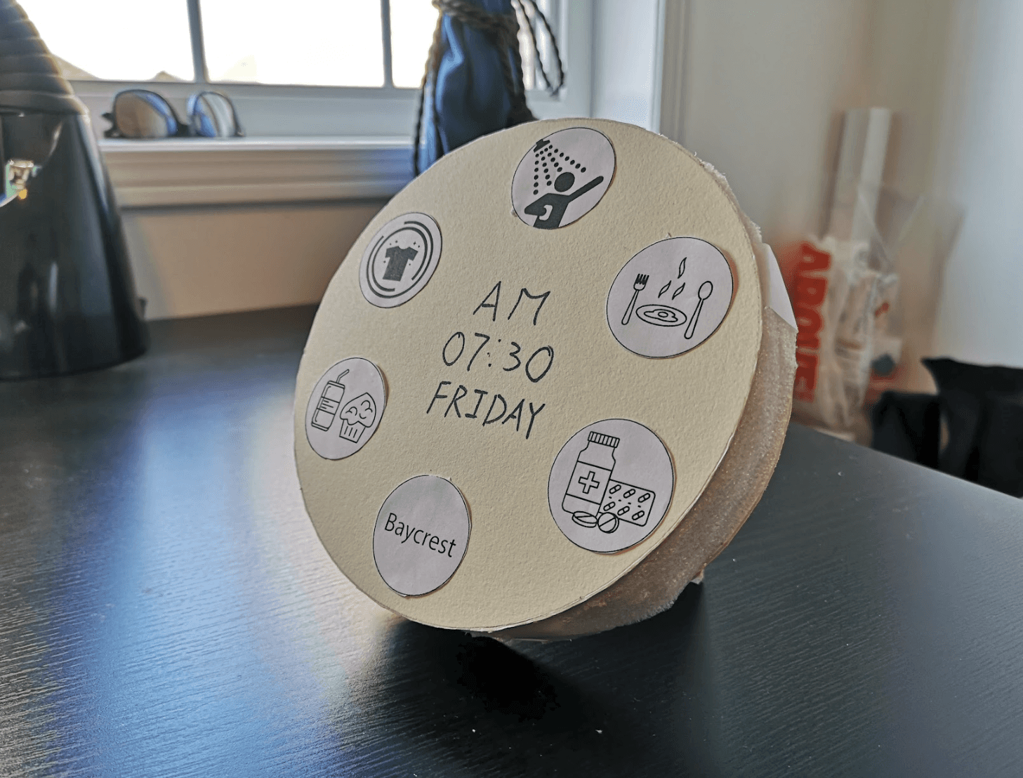 Modern home office setup with a monitor, ergonomic chair, keyboard, and indoor plants near a window with blinds.