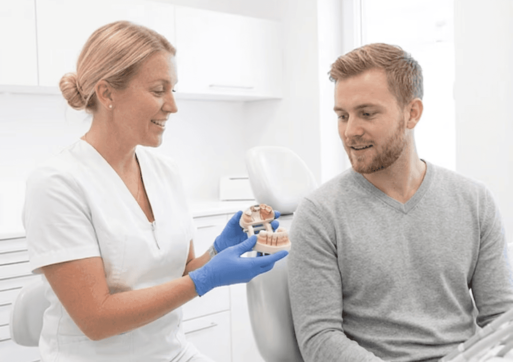 Dentist explaining a dental crown treatment for toothache caused by tooth damage