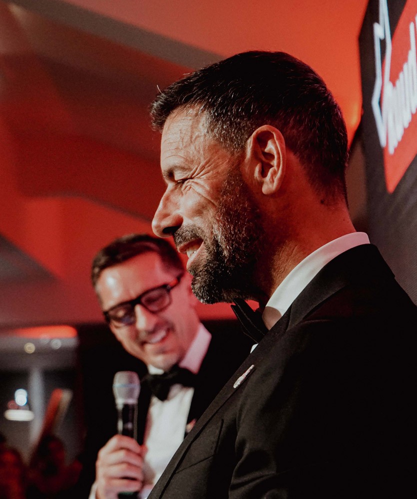 two men in suits talking an event