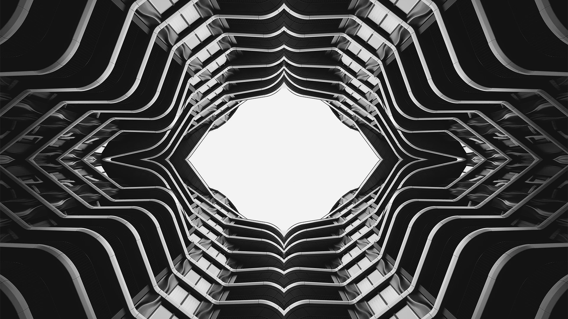 Abstract geometric pattern of building balconies against bright sky