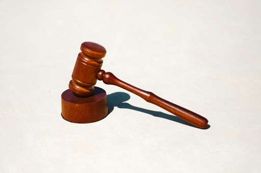 A wooden gavel resting on a light surface, symbolizing law and justice.