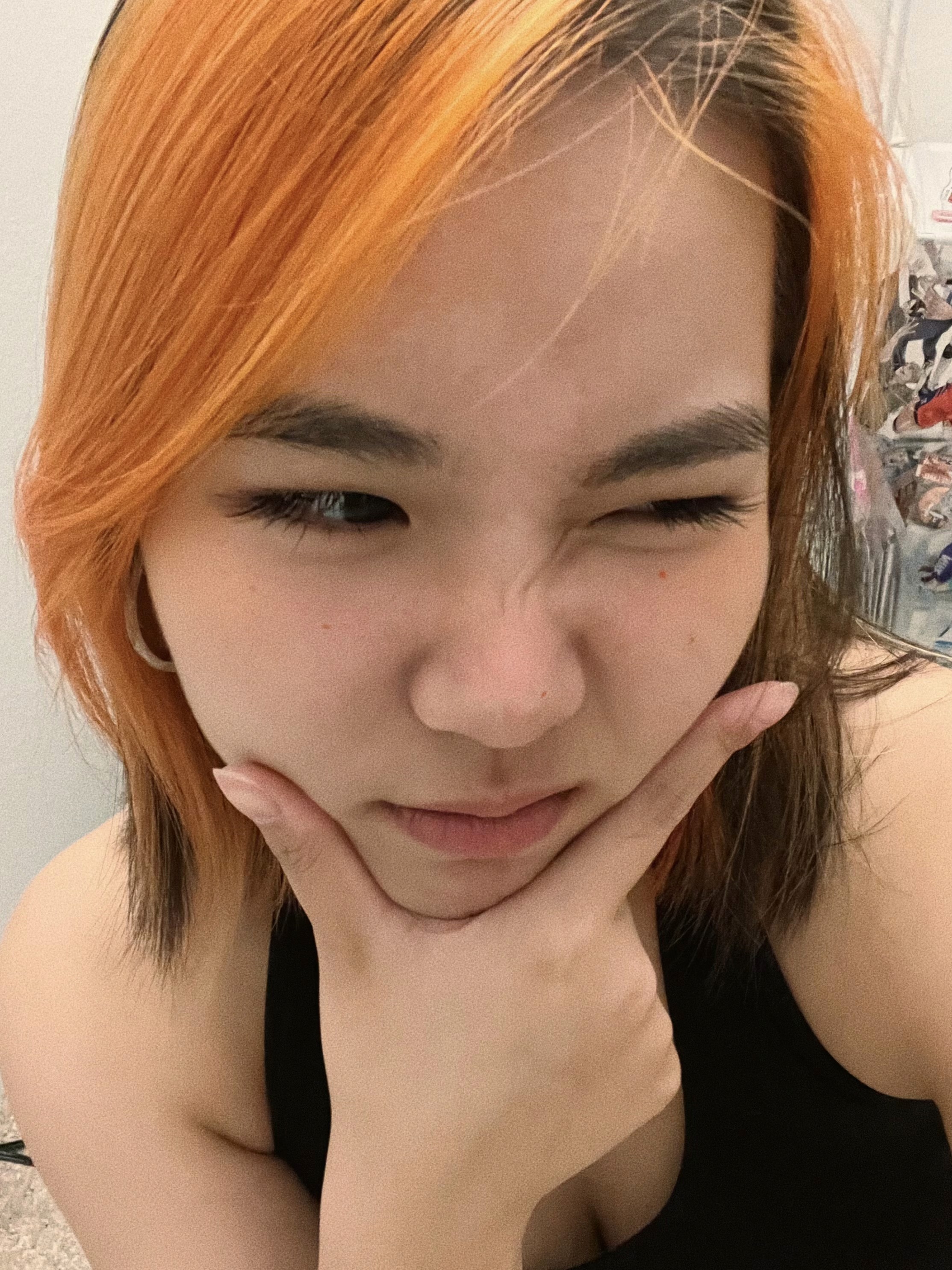 Close-up portrait of Melody with short orange hair, she was a very happy girl before she started making art.