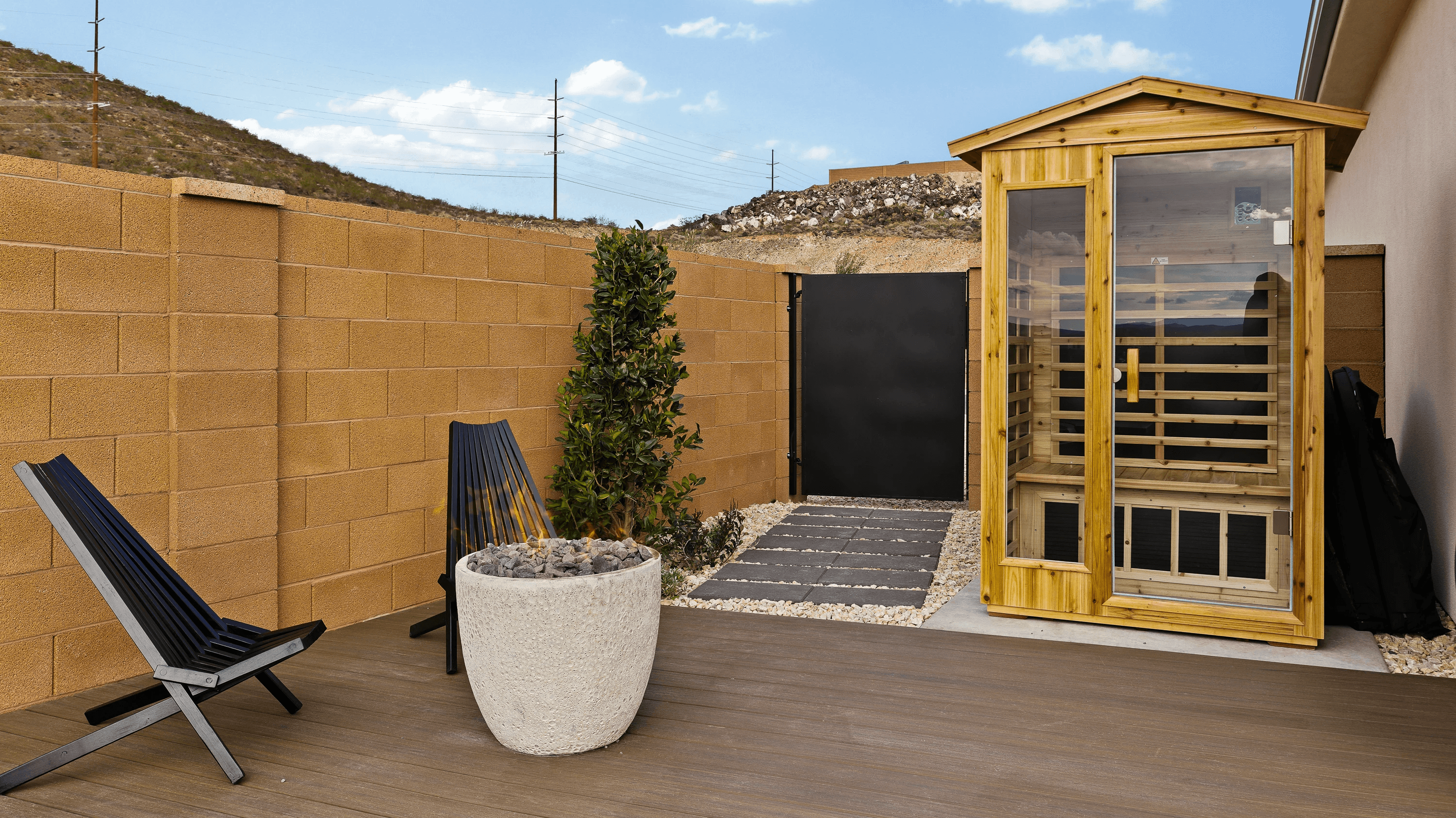 Backyard in Hurricane, Utah with an outdoor sauna, fire pot, and custom-built deck for entertaining and relaxation.