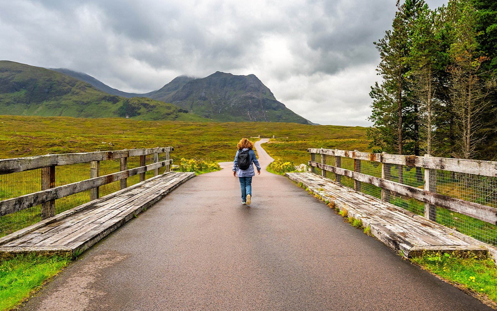 Hiker in Glencoe overlooking Loch Ness and the Highlands, Scotland.
