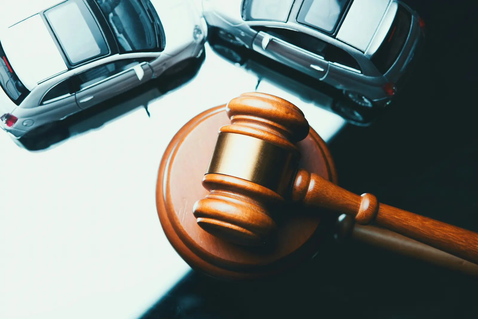 Judge’s gavel and cars symbolizing a DUI court case