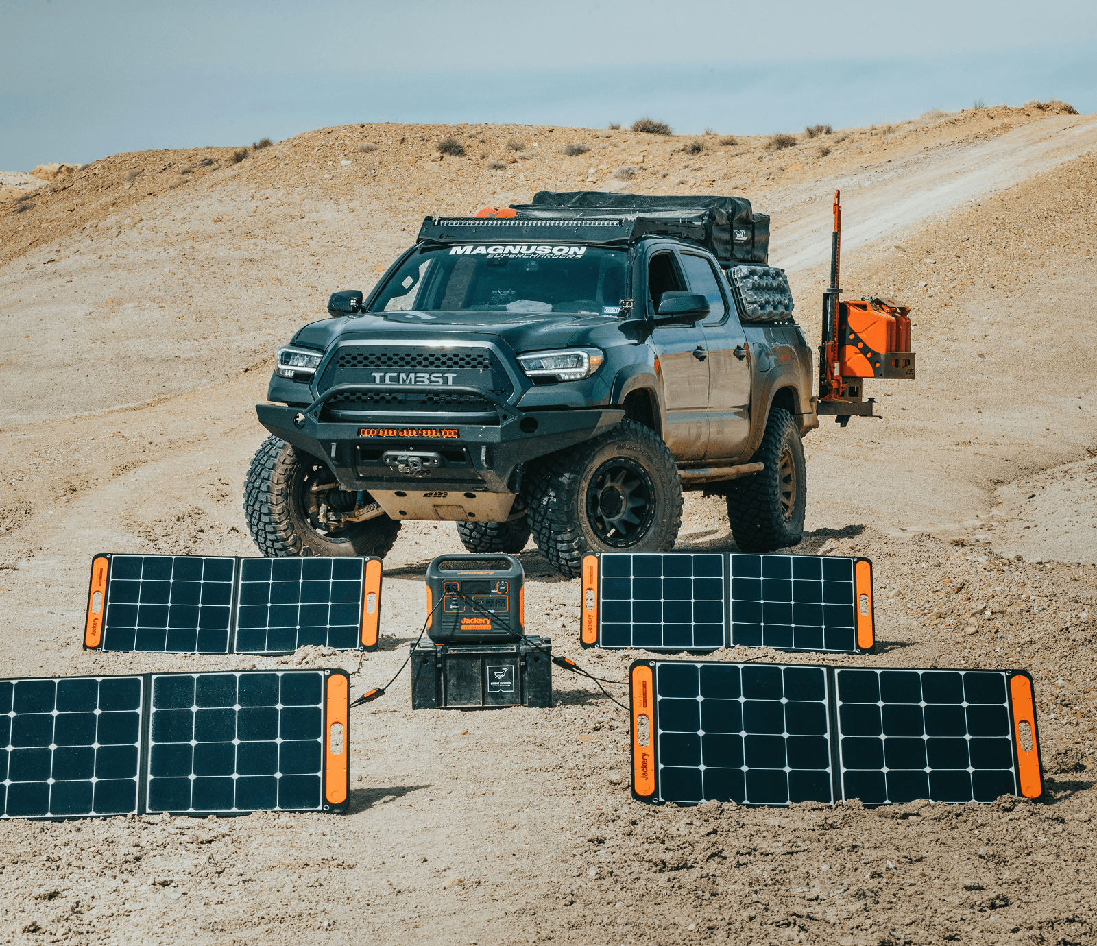 Golden retriever dog sitting near solar panels and camper