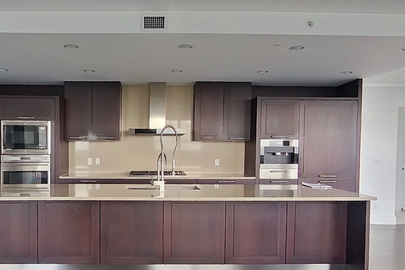 Eau Claire kitchen before: dark wood cabinetry and a long stone-topped island