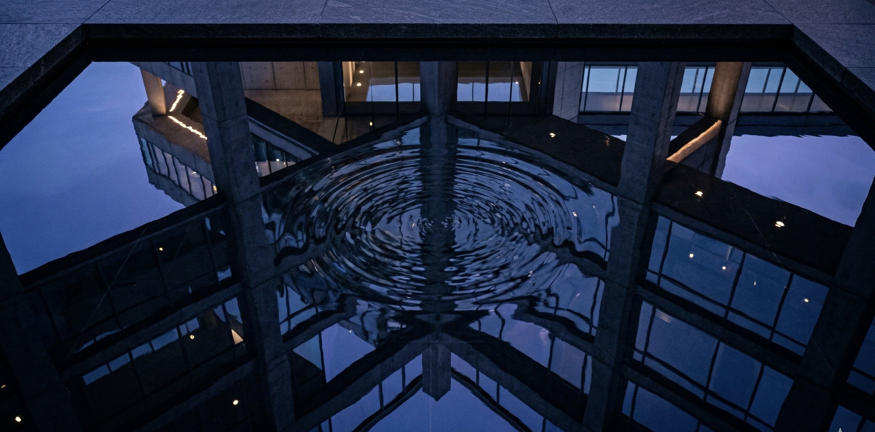 a gray couch with four pillows on it