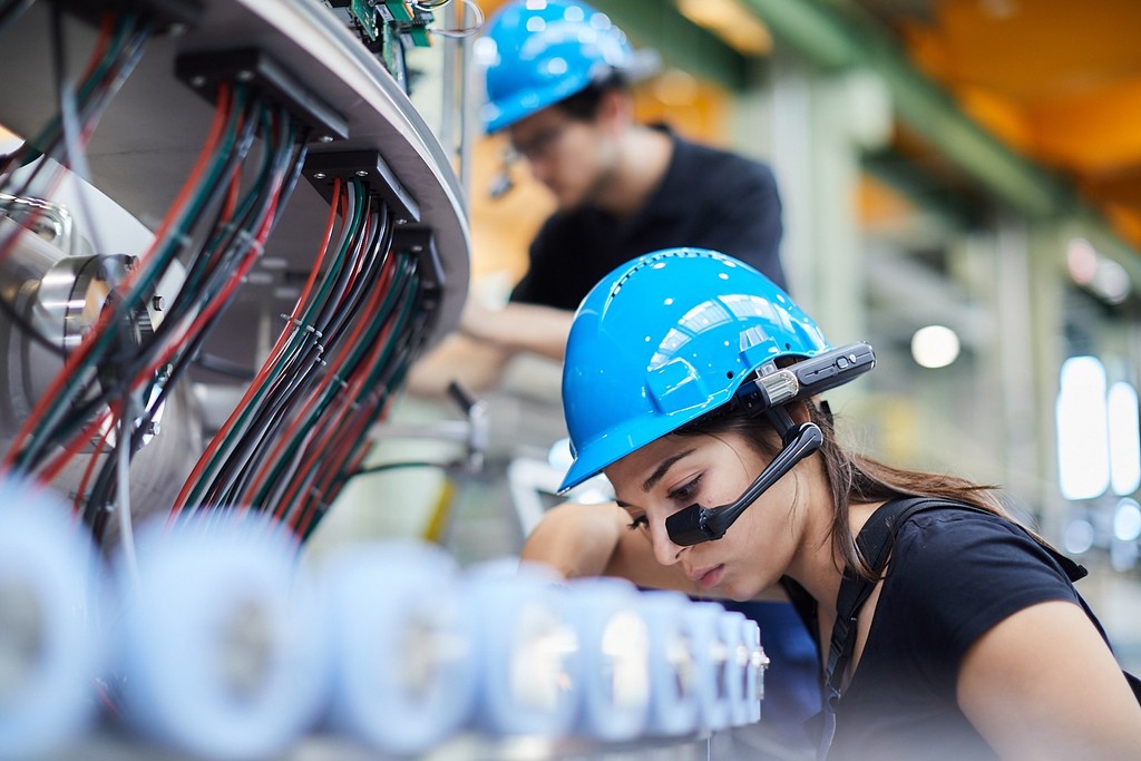 An industrial worker wearing a RealWear headset