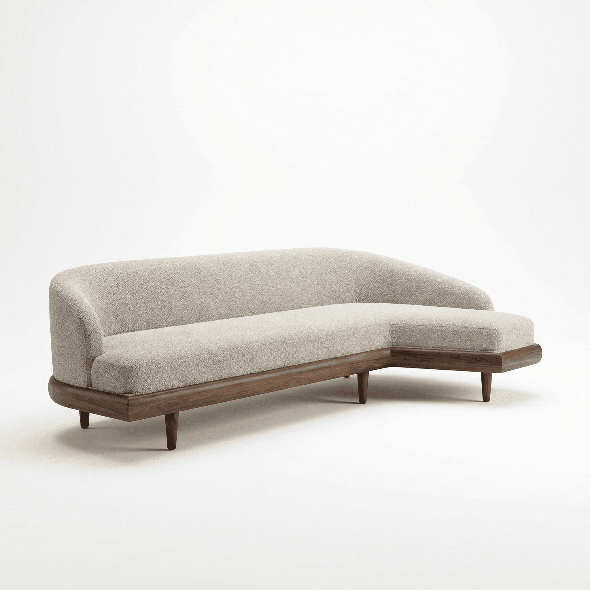 Three‑seater upholstered sofa with curved backrest, chaise extension, and wooden base