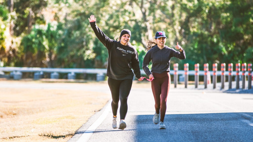 Manahil Jafri running with a guide