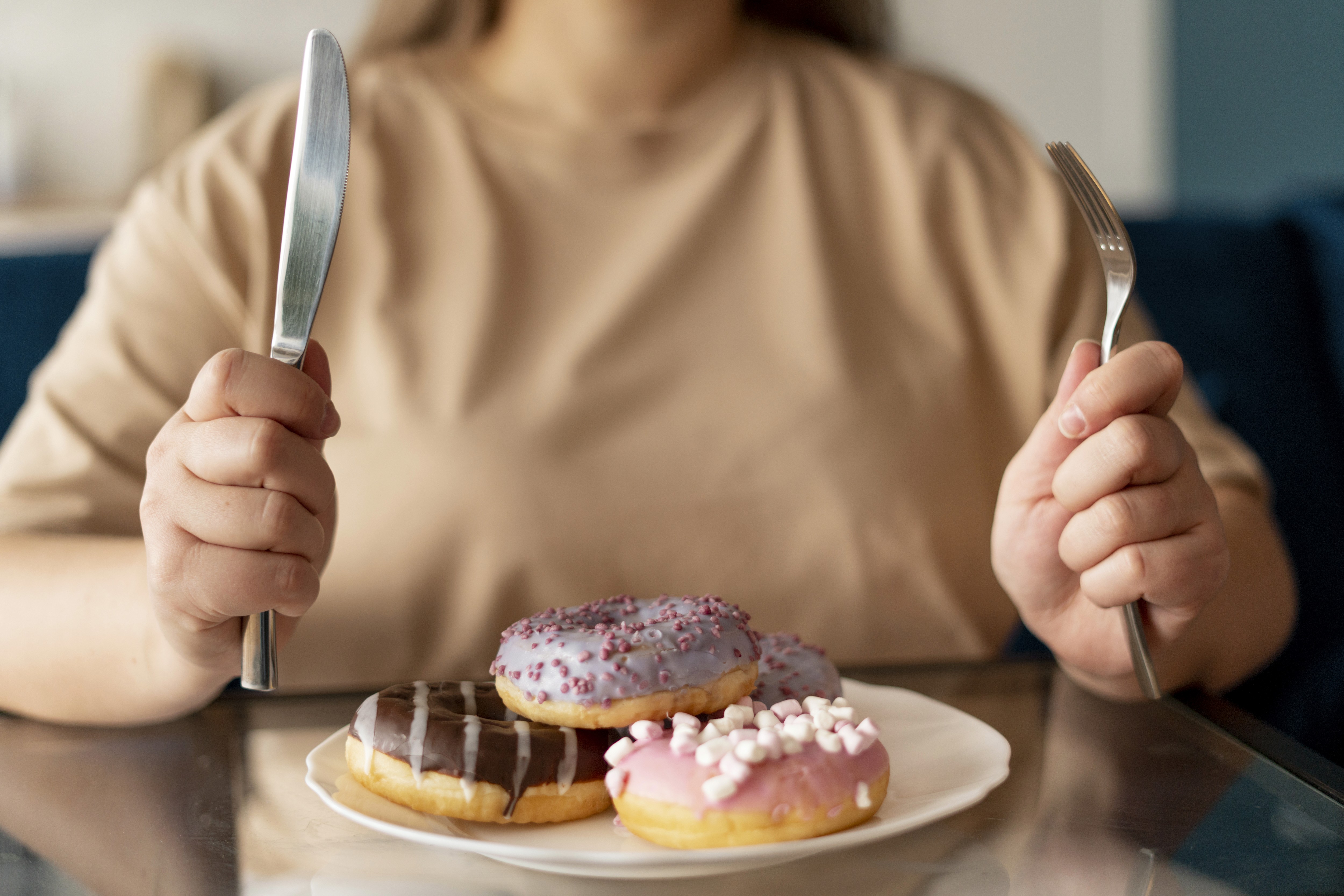 woman trying to eat donuts with eating disorder