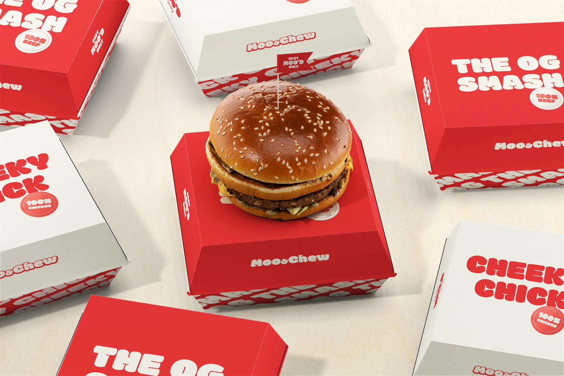 Two variations of a branded cardboard burger box packaging design by Studio Liminal with a fresh burger resting on top, showcasing fast food visual identity variants.