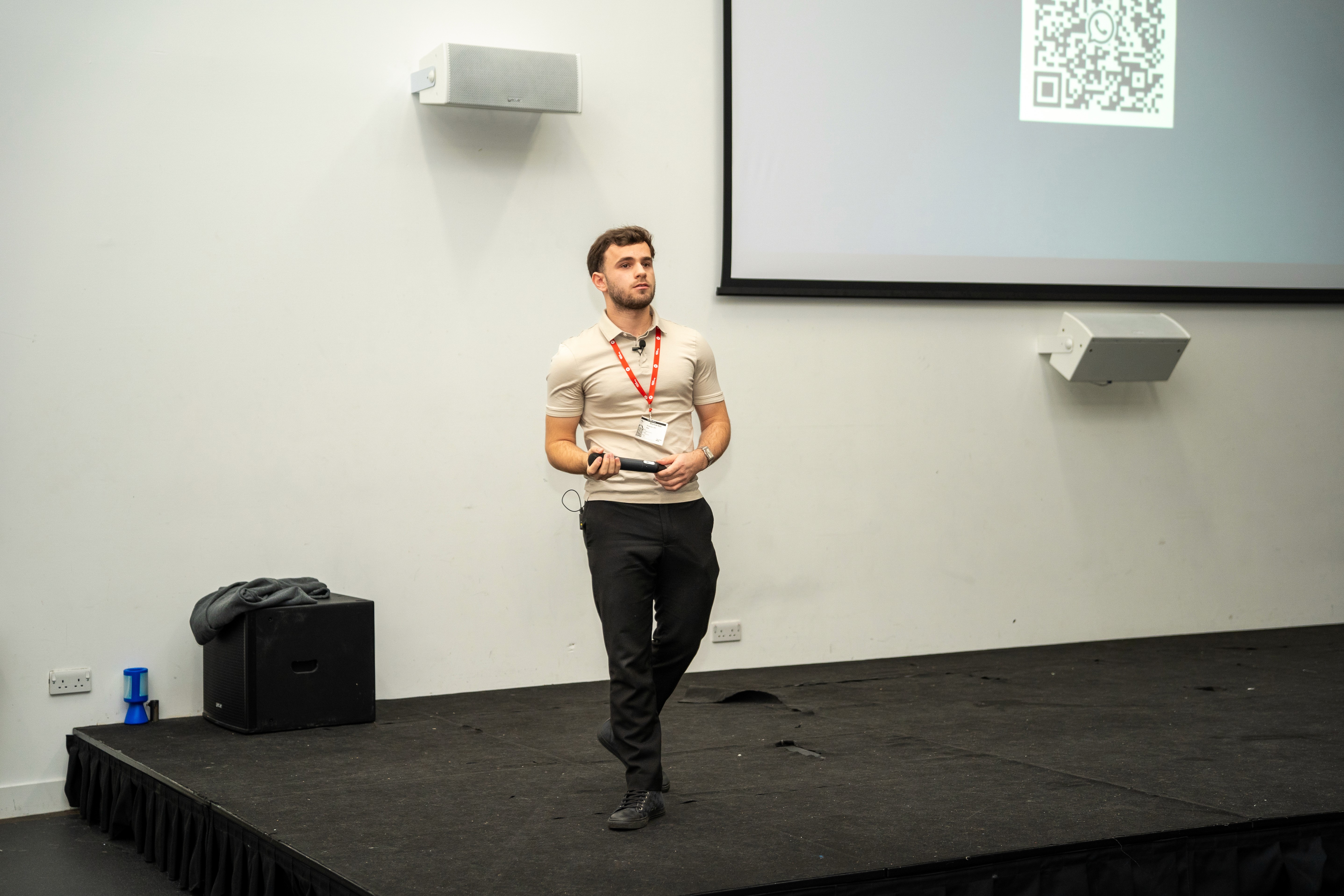 Woman in conical hat rides bicycle down street.