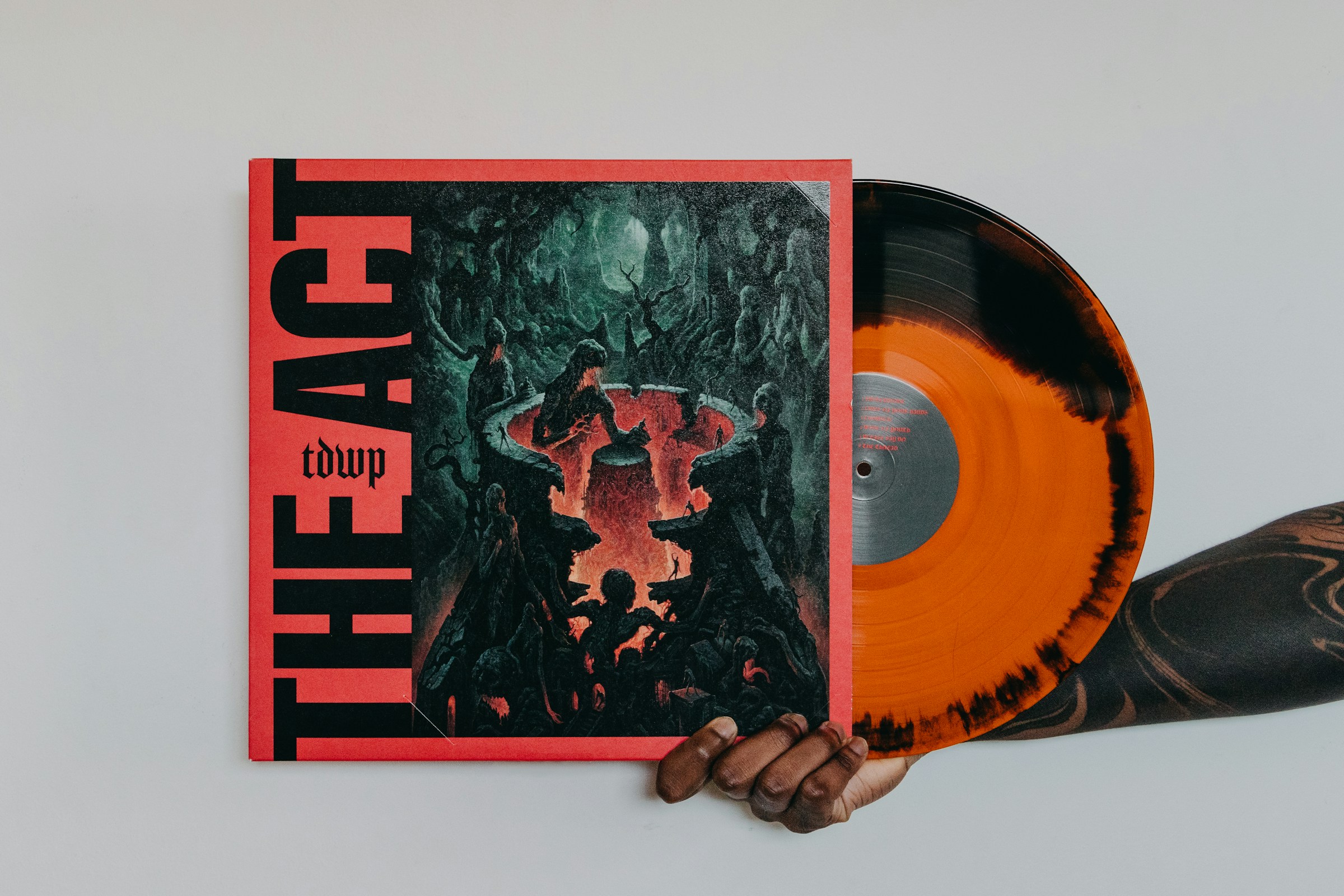 man holding an album - What Does EP Mean in Music