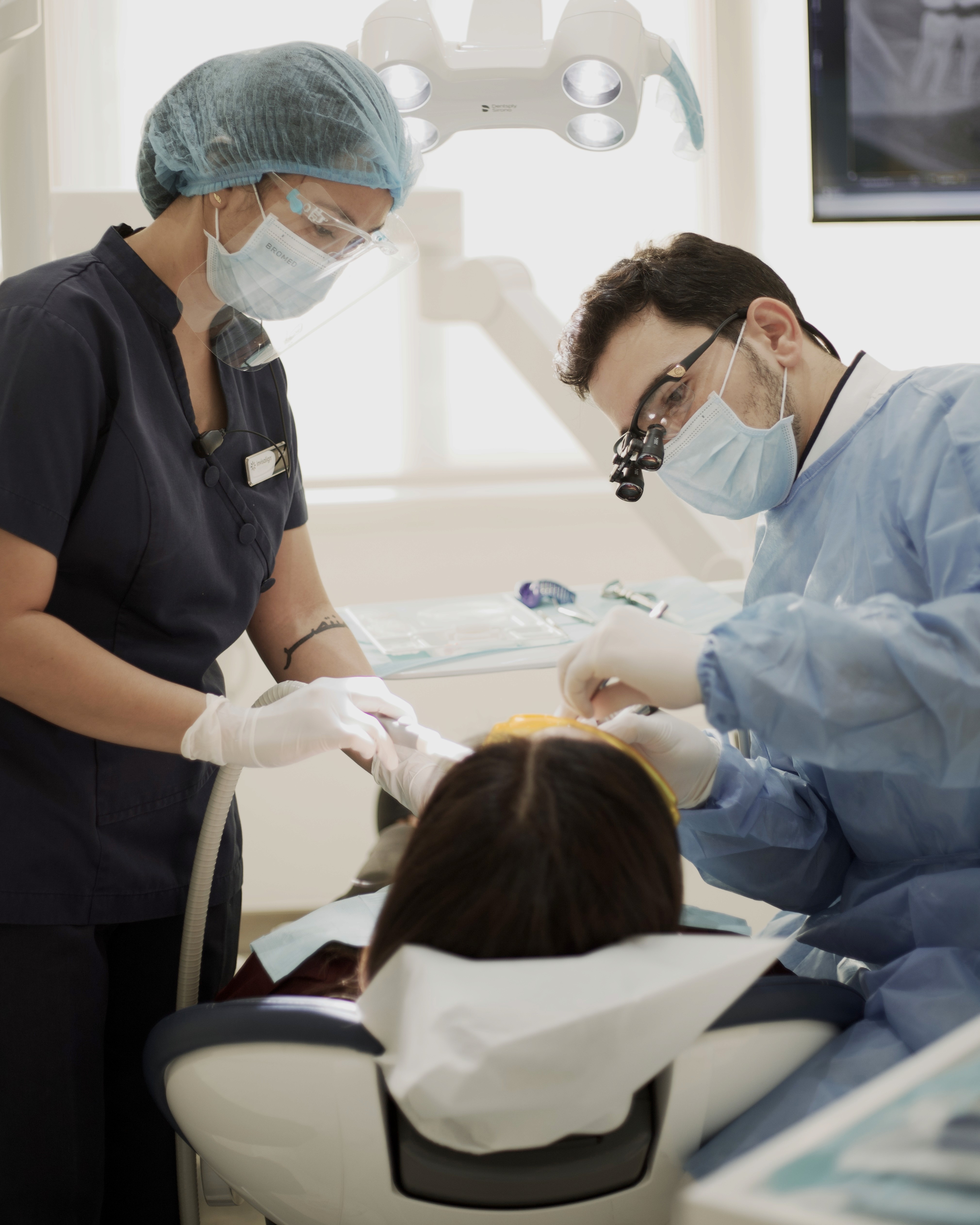 Gummy smile treatment with a cosmetic dentist, showing careful gum contouring and precise assessment for natural-looking results.