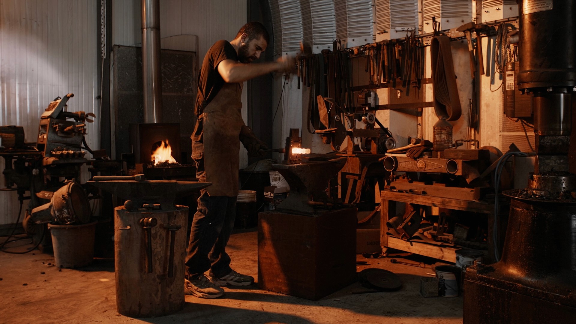 A blacksmith by the fire while is working on his studio in Larnaca, Cyprus