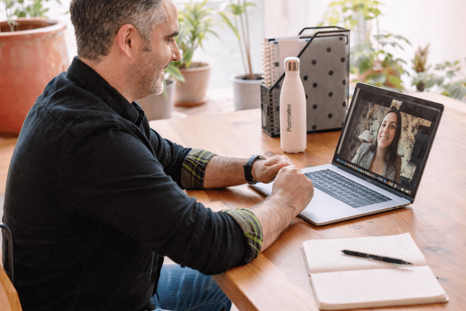 man in black sweater using macbook pro