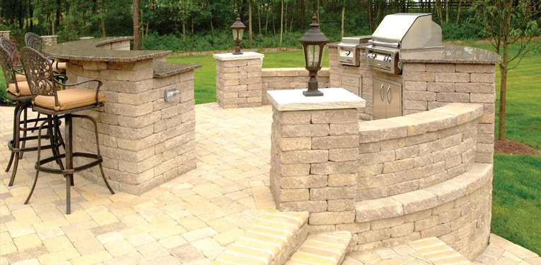 Raised outdoor bar and grill area built with beige block masonry