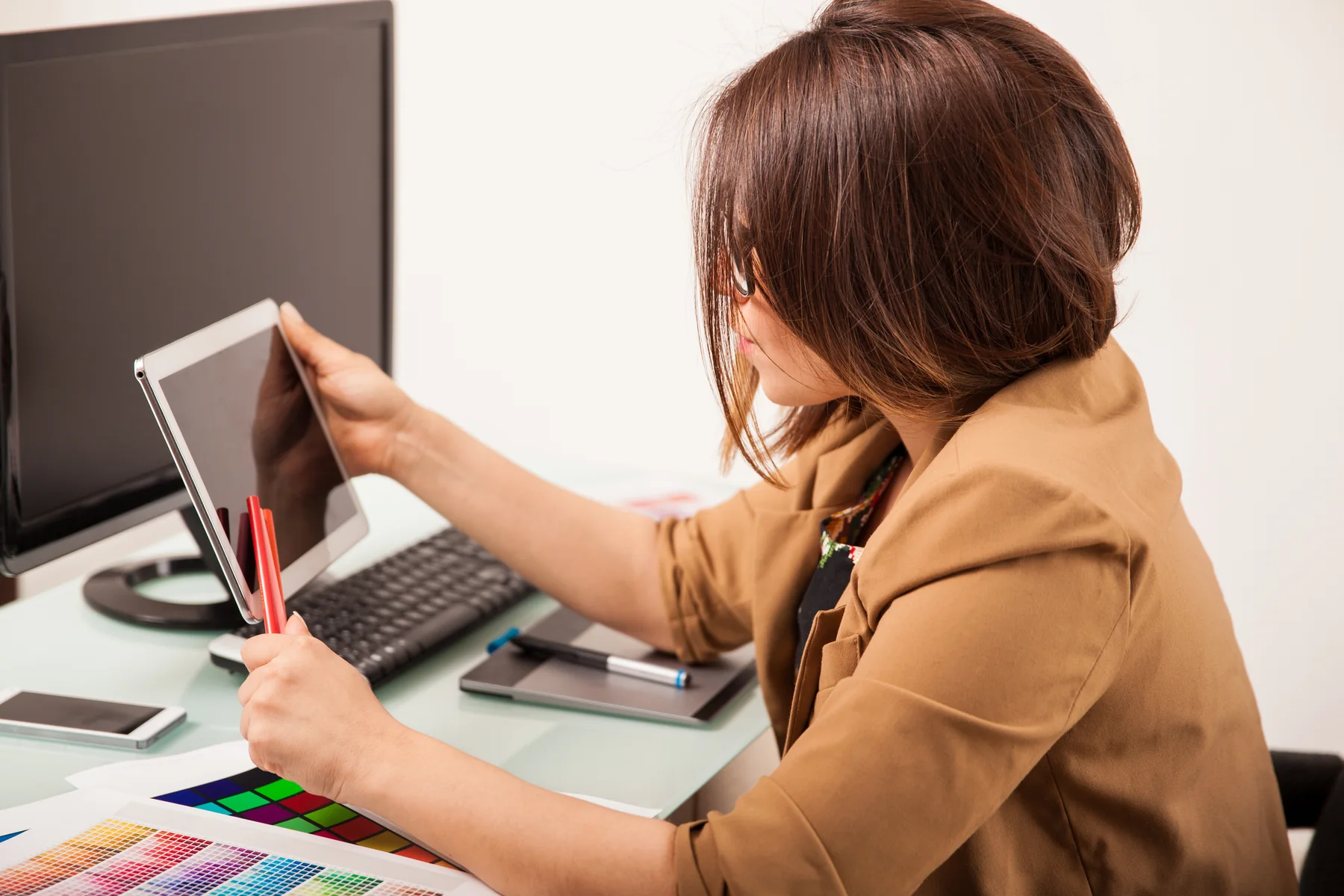 Creative Woman Working with Tablet at Office Desk